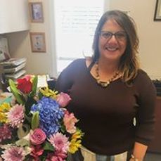 Heather Majka owner of citizens insurance solutions with flowers